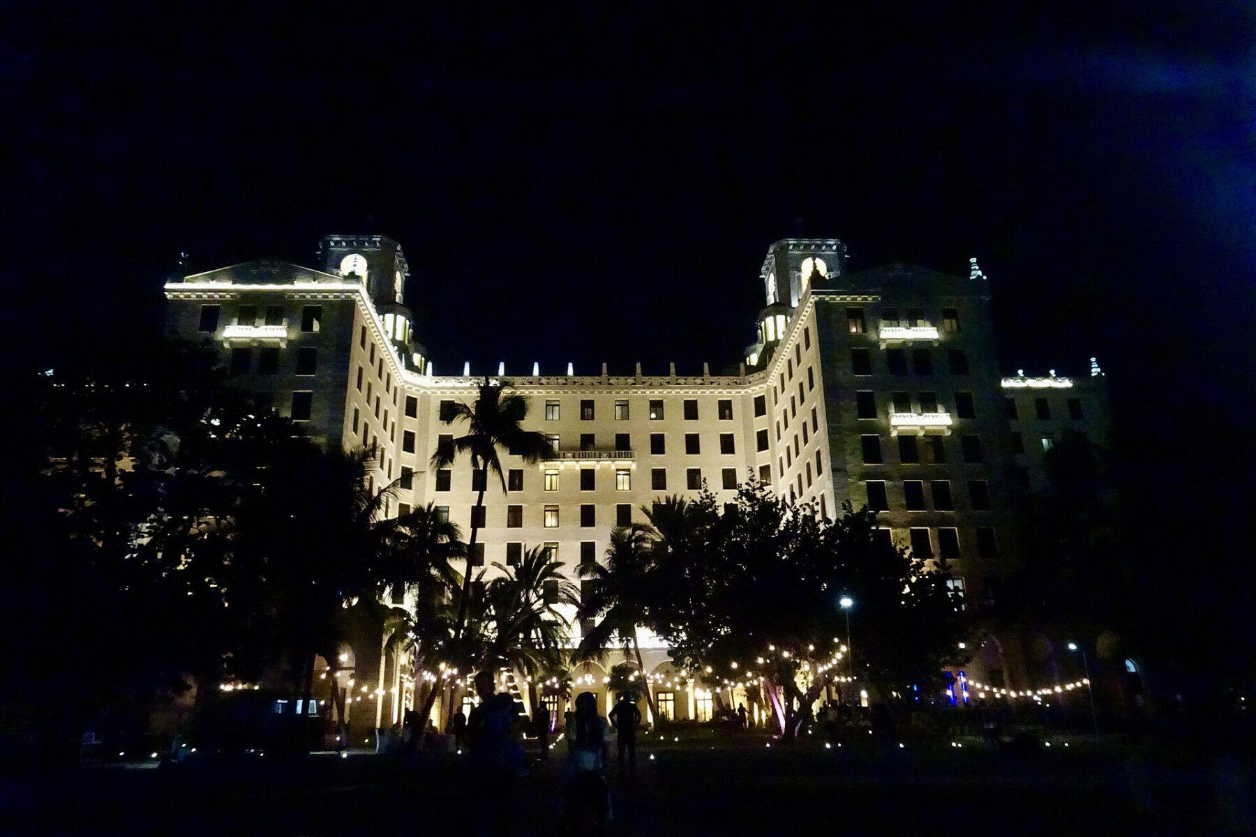 A large building lit up at night in Havana, Cuba