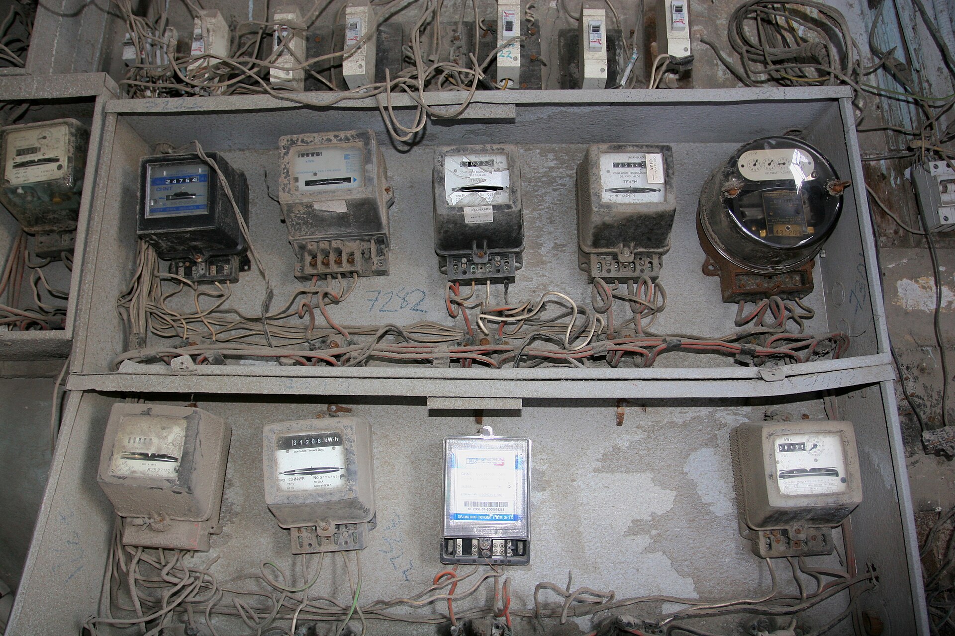 Old electricity meters and tangled wiring in a building in Havana, Cuba