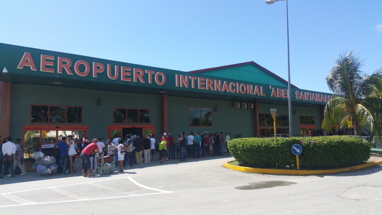 Front of the Abel Santamaría International Airport terminal in Santa Clara, Cuba, with people queuing outside the entrance