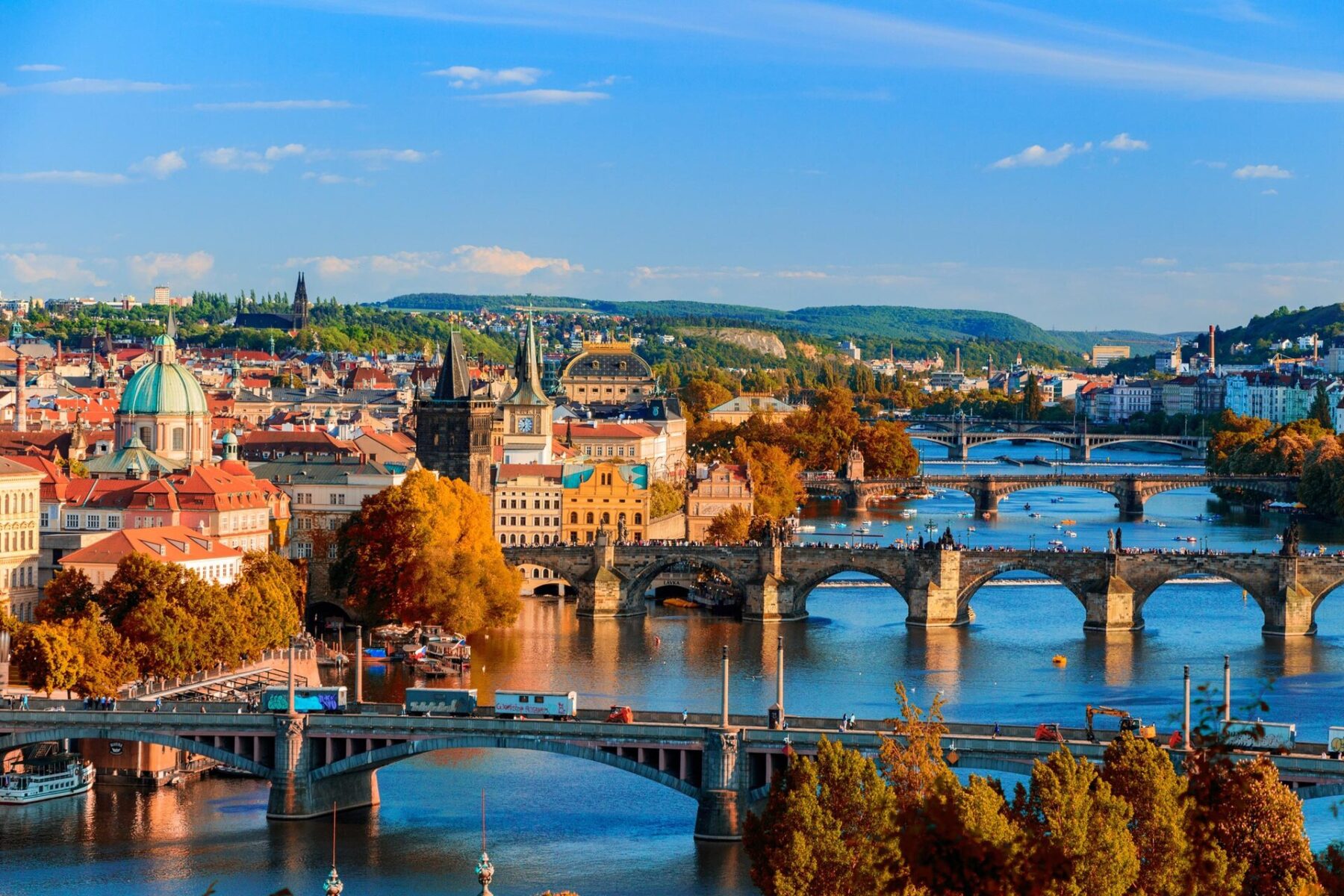 Bridges over the Vltava river in Prague in autumn, with the old town and Prague Castle in the distance