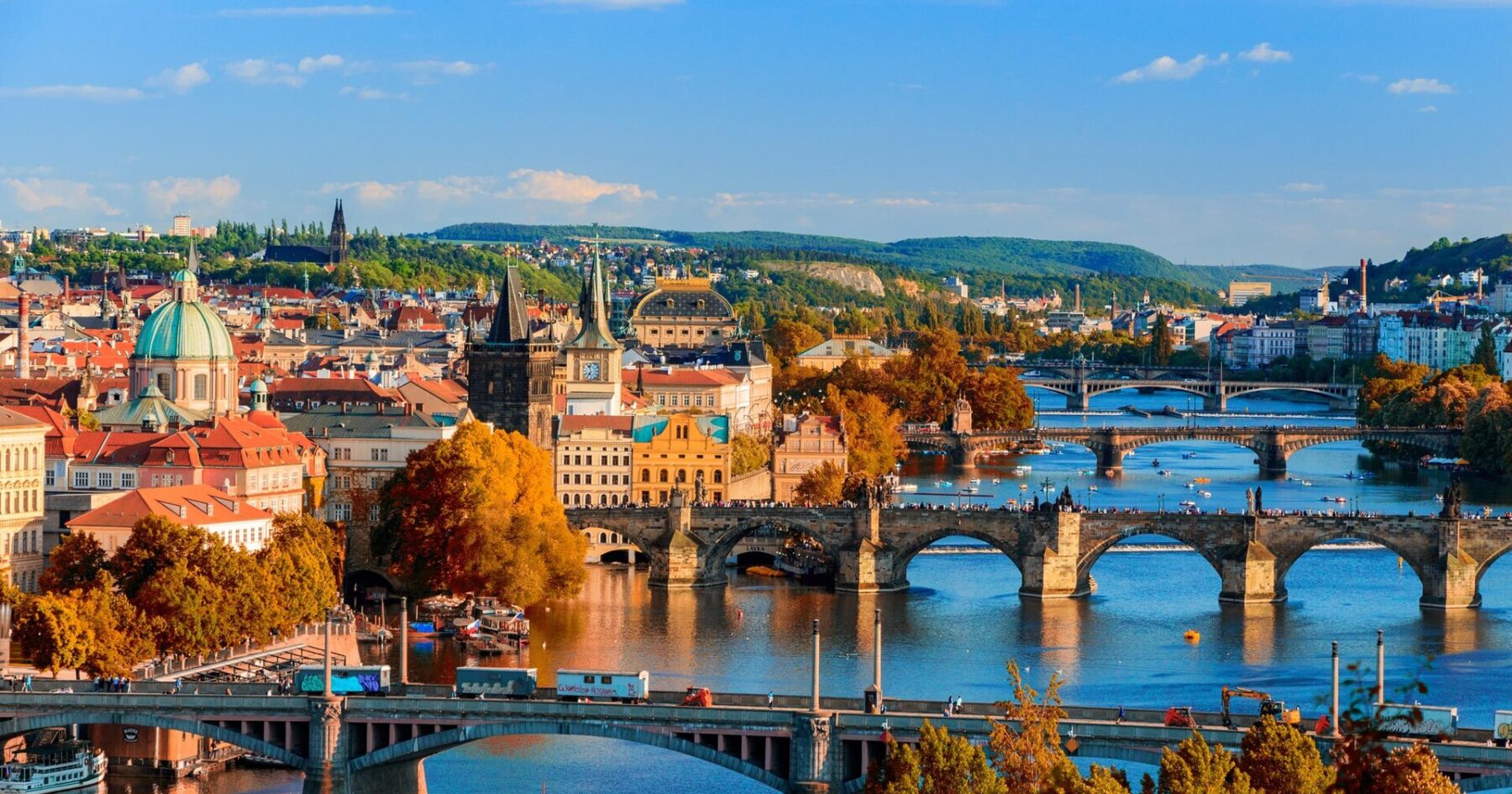Bridges over the Vltava river in Prague in autumn, with the old town and Prague Castle in the distance