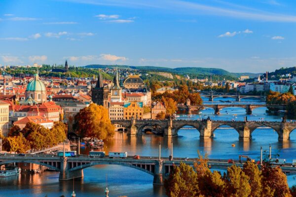 Bridges over the Vltava river in Prague in autumn, with the old town and Prague Castle in the distance