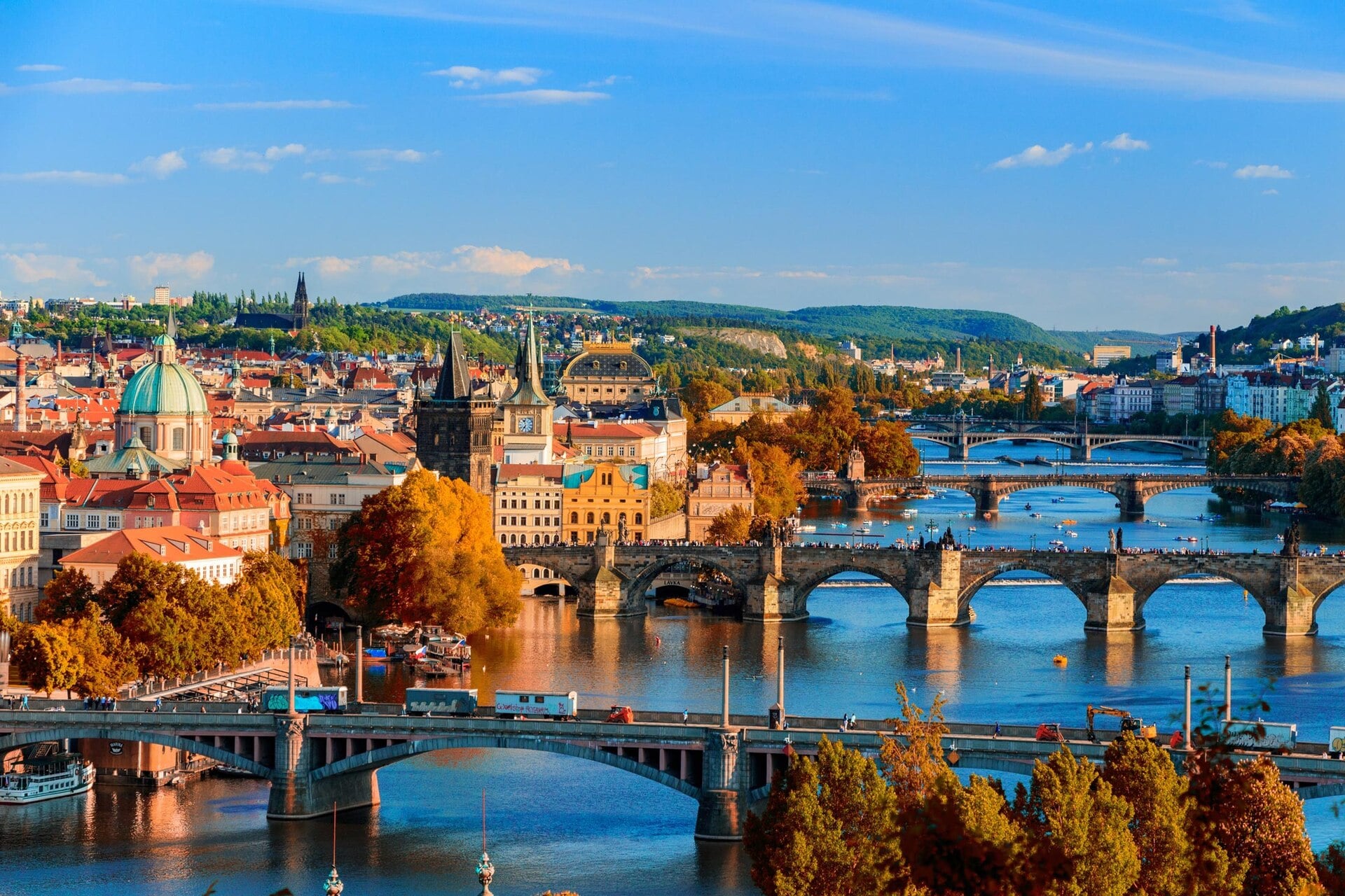 Bridges over the Vltava river in Prague in autumn, with the old town and Prague Castle in the distance