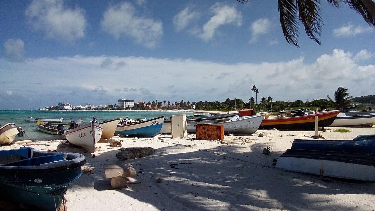 Artisanal fishing boats pulled up on a white sand beach on San Andrés island, Colombia