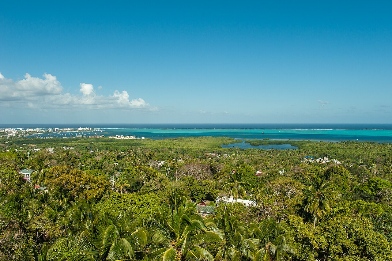 View over the green interior of San Andrés island, Colombia, toward the turquoise reef and open Caribbean Sea