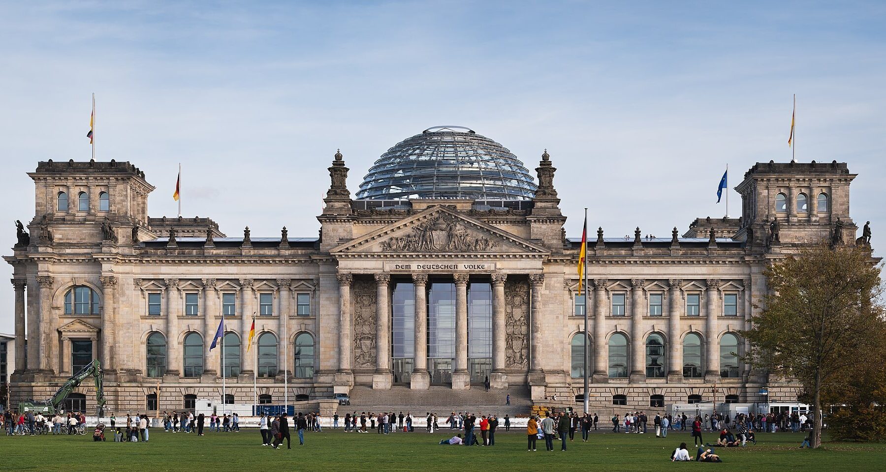 The west facade of the Reichstag building in Berlin with its glass dome and the inscription Dem Deutschen Volke