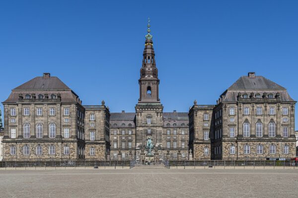 Christiansborg Palace in Copenhagen, home of the Danish parliament, with its tall tower under a blue sky