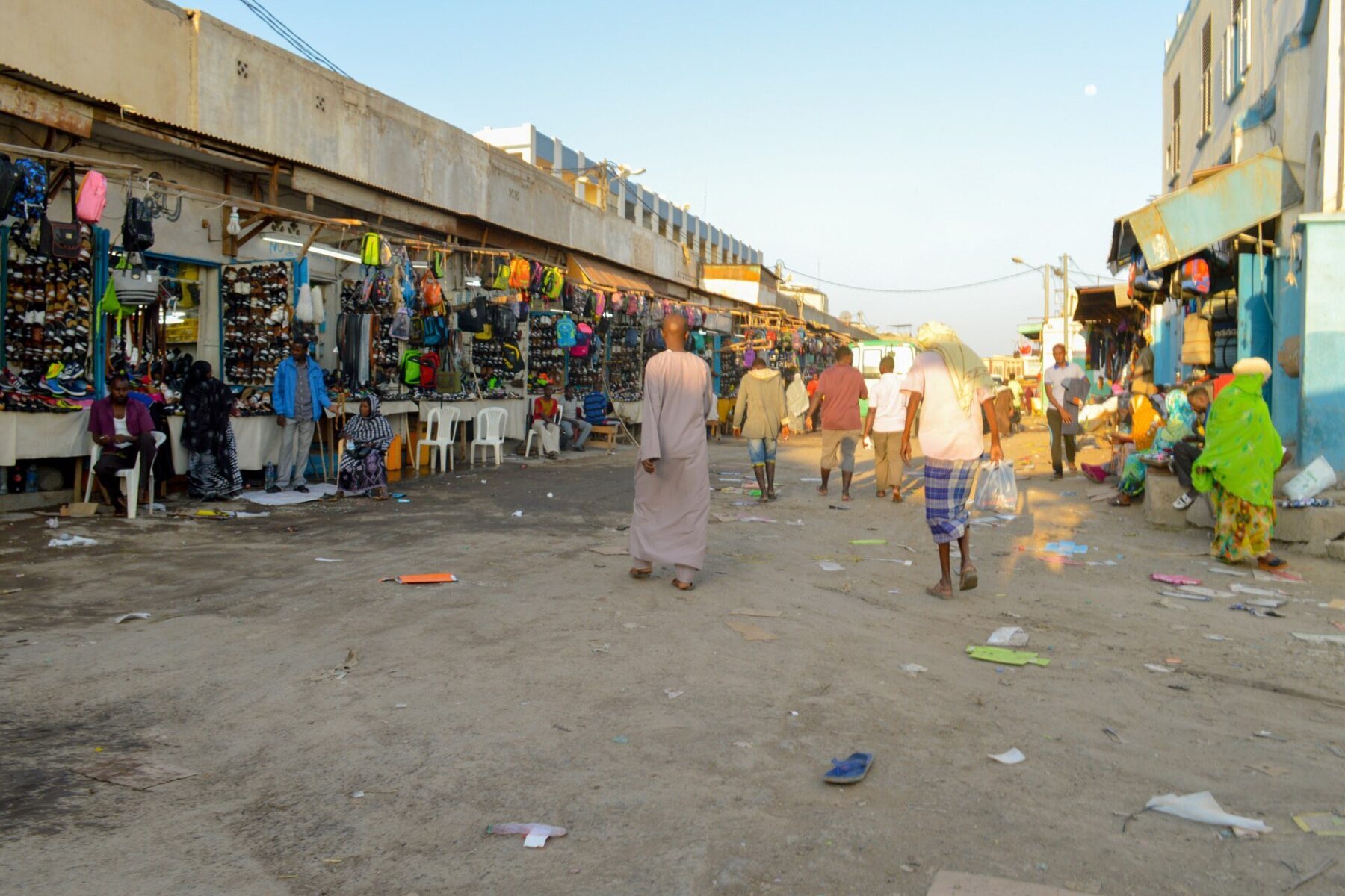 Shoppers and stalls selling bags and shoes at Les Caisses market in Djibouti City