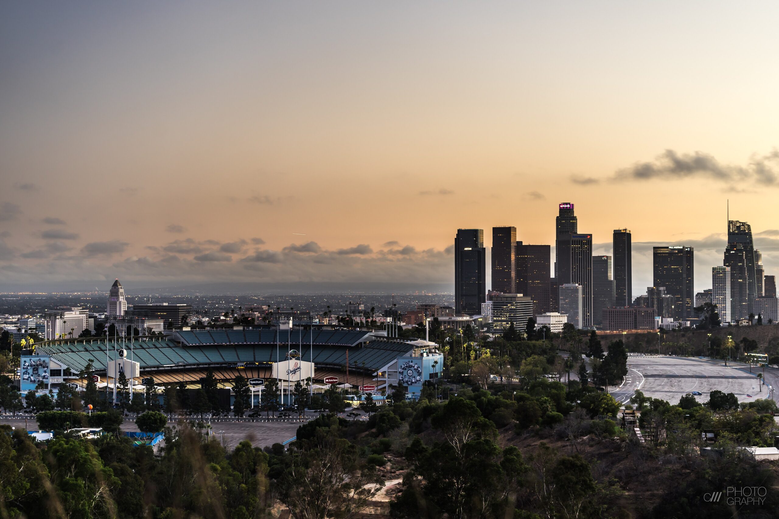 Dodger Stadium in Los Angeles with the downtown skyline at dusk