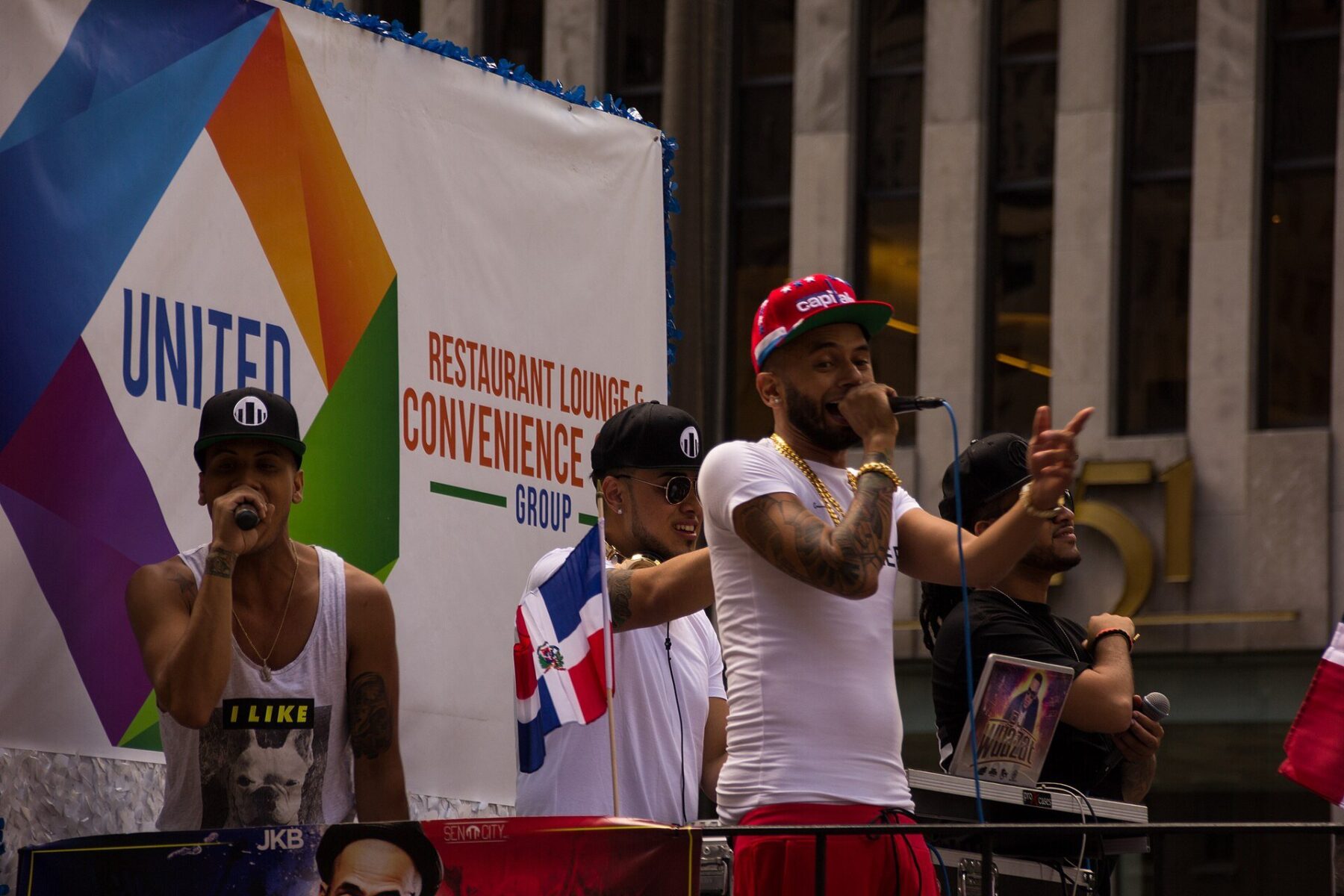 Performers with a Dominican flag on a parade float at the Dominican Day Parade in New York City