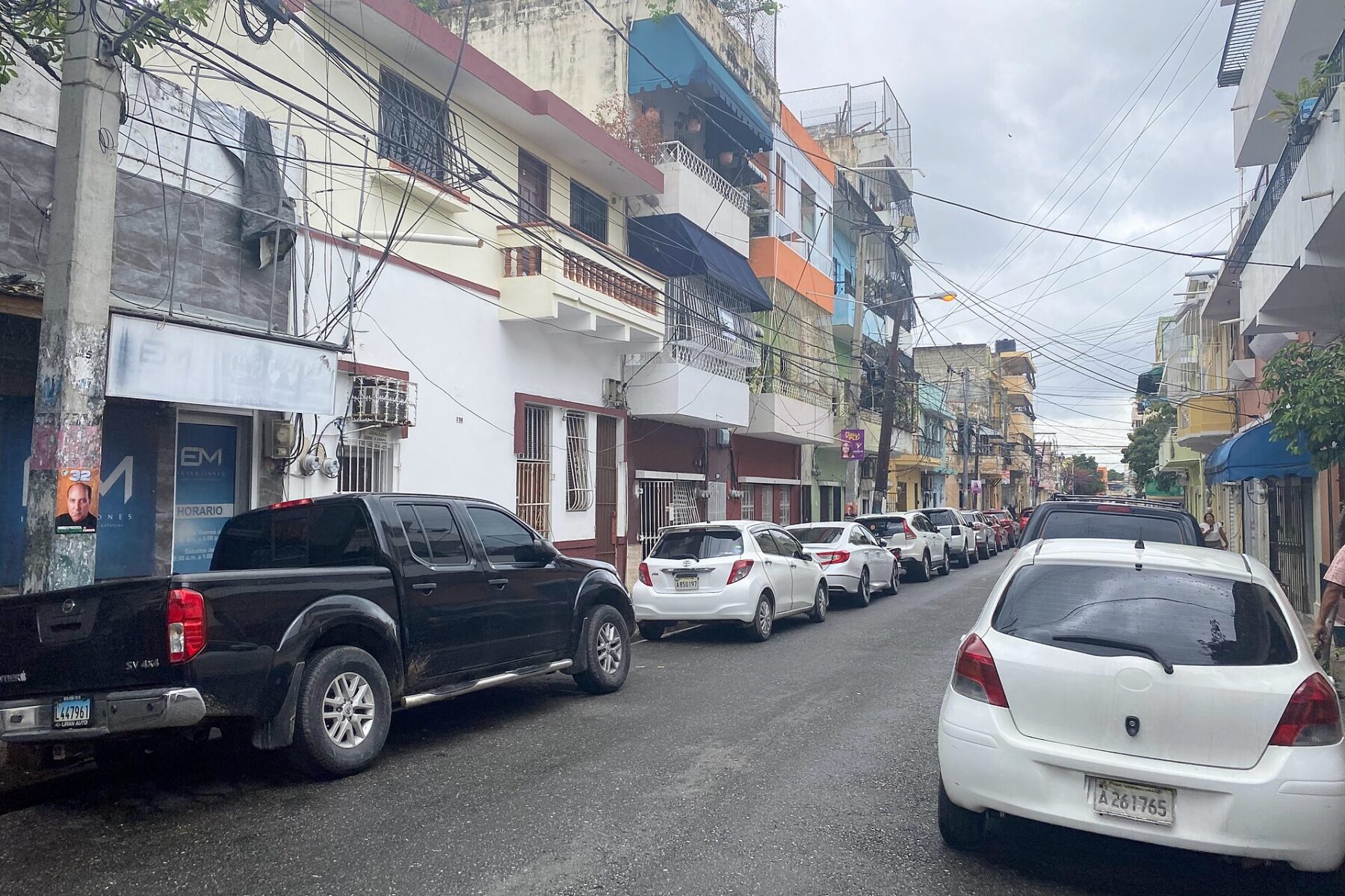 A residential street with parked cars in Santo Domingo, Dominican Republic