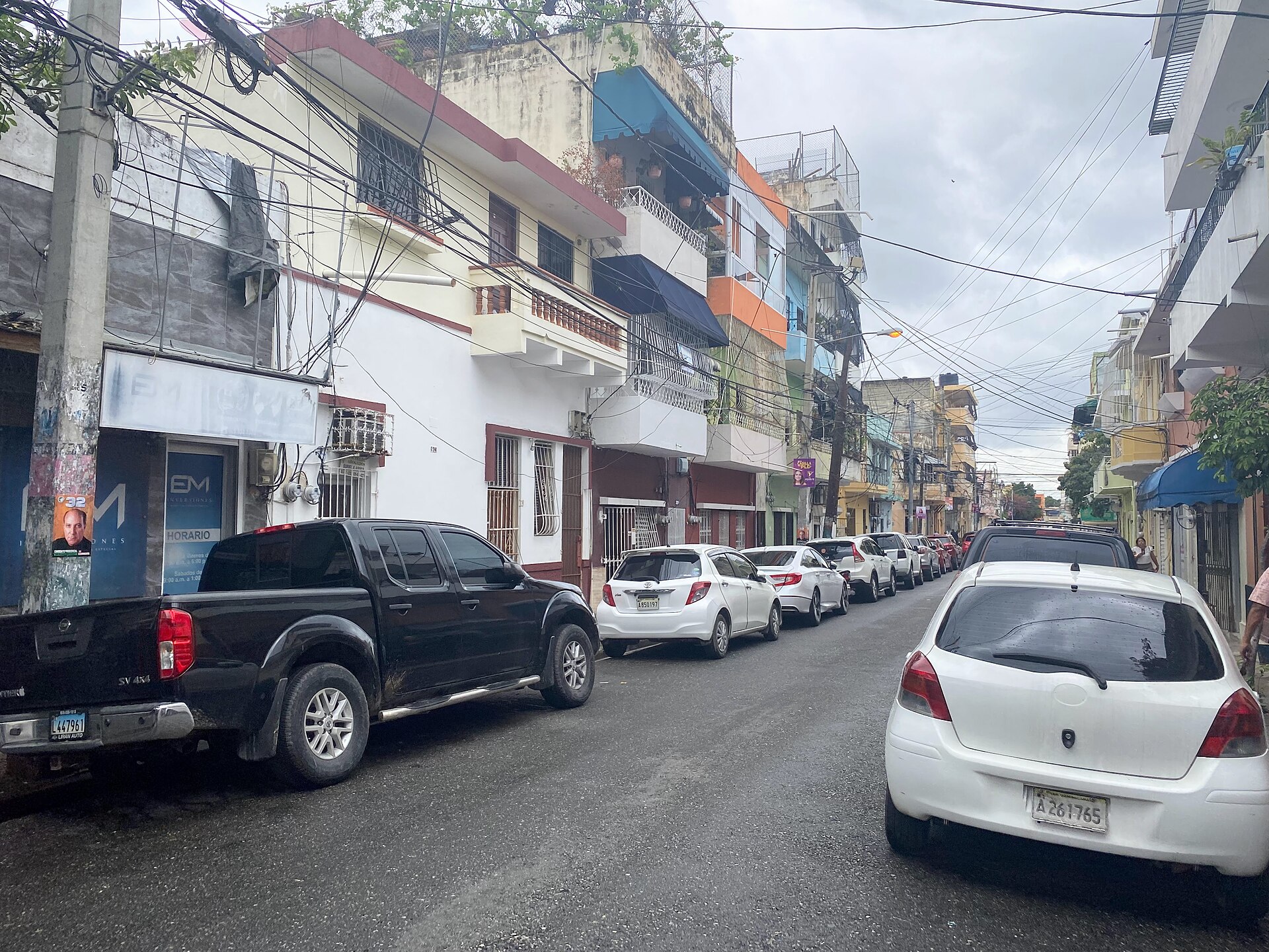 A residential street with parked cars in Santo Domingo, Dominican Republic