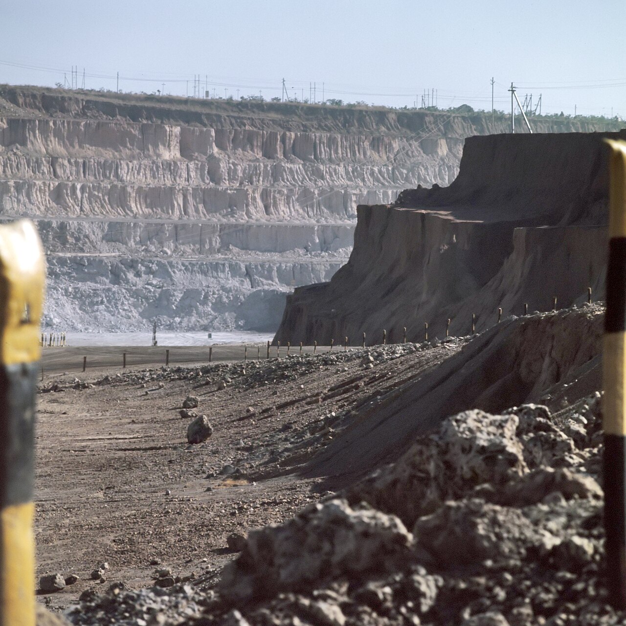 Terraced walls of an open-pit copper mine at Kolwezi in southern DR Congo, with a haul road along the pit edge