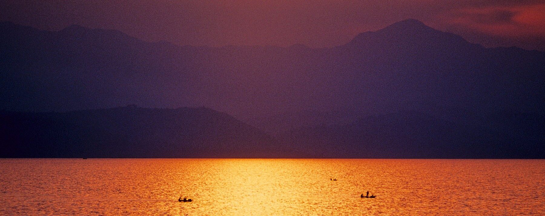 Fishing boats on Lake Kivu at sunset seen from Goma, DR Congo