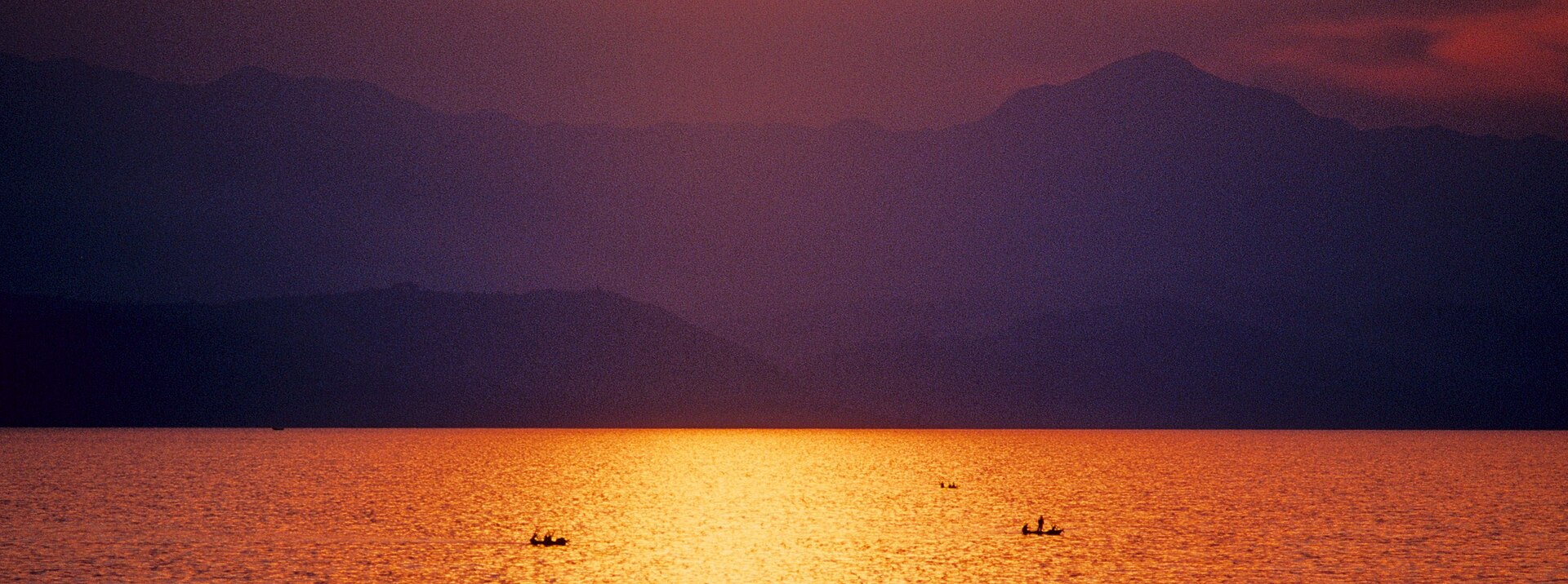 Fishing boats on Lake Kivu at sunset seen from Goma, DR Congo