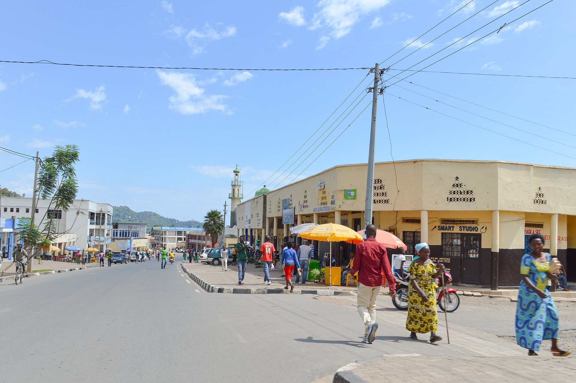 Pedestrians and shops on a main street in Rubavu, the Rwandan border town next to Goma