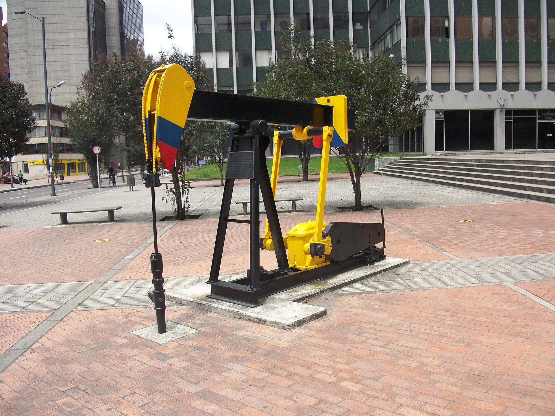 A yellow, blue and red oil pumpjack monument on a Bogotá plaza near the Ecopetrol headquarters in Colombia