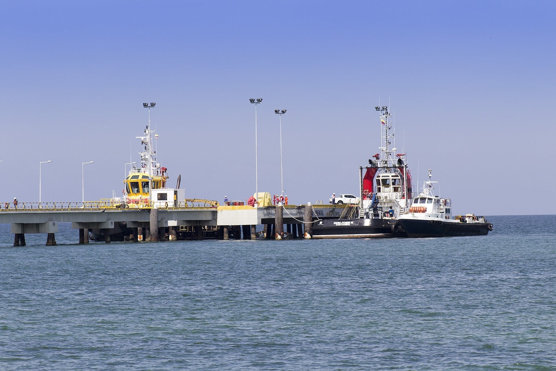 Tugboats moored beside the oil pier at Coveñas on Colombia’s Caribbean coast, with the Ecopetrol name on the pier edge