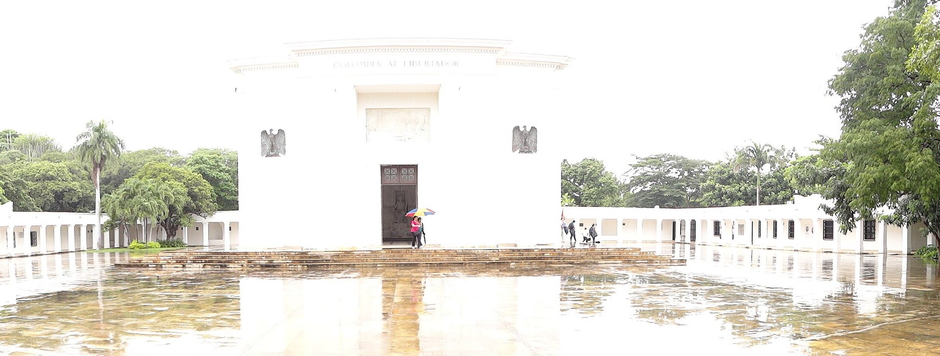 The white Altar de la Patria monument and colonnades at the Quinta de San Pedro Alejandrino in Santa Marta, Colombia, on a rainy day