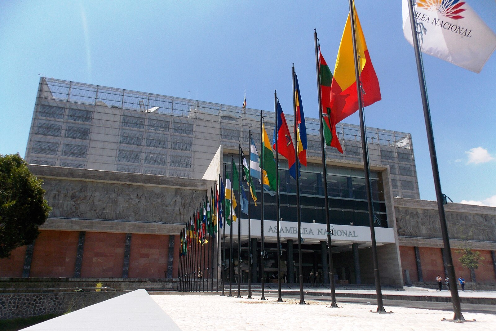 The Asamblea Nacional building and a row of flags in Quito, Ecuador