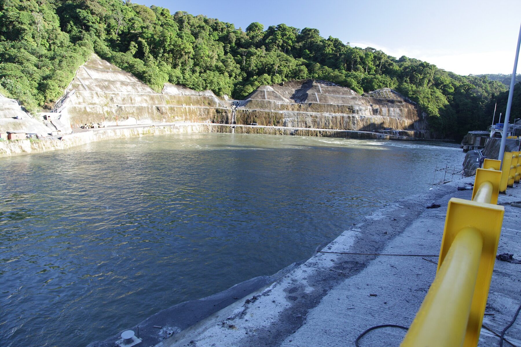River water in the intake basin below forested slopes at the Coca Codo Sinclair plant in Ecuador