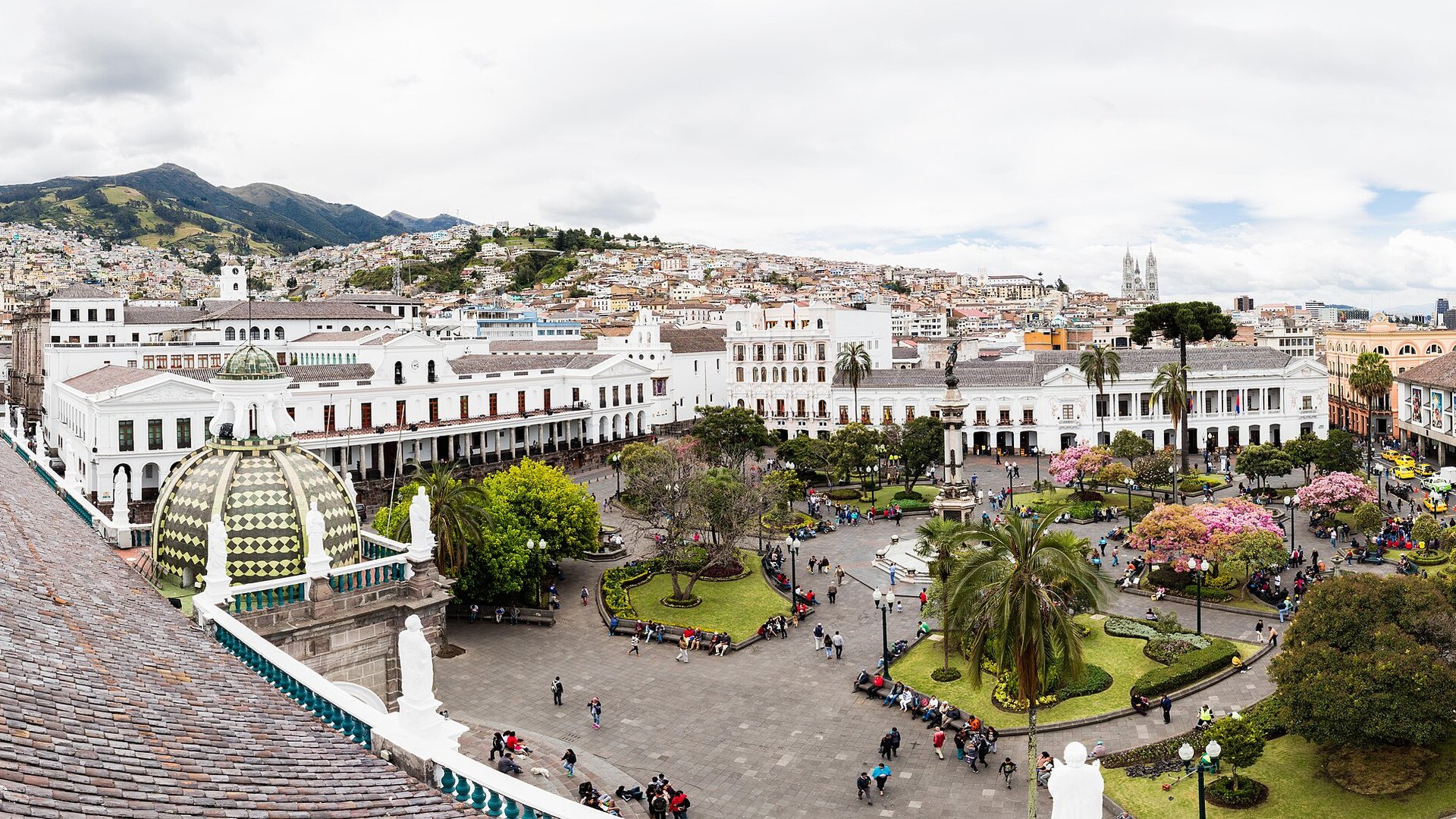 Plaza Grande, the main square of Quito's historic centre, with white colonial buildings, gardens and hills behind