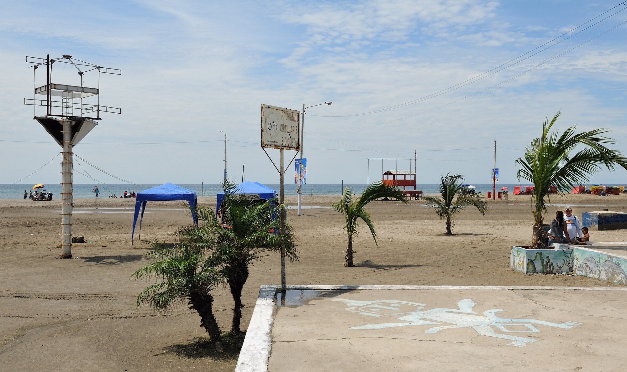 Palm trees and tents on Murciélago beach in Manta, Ecuador