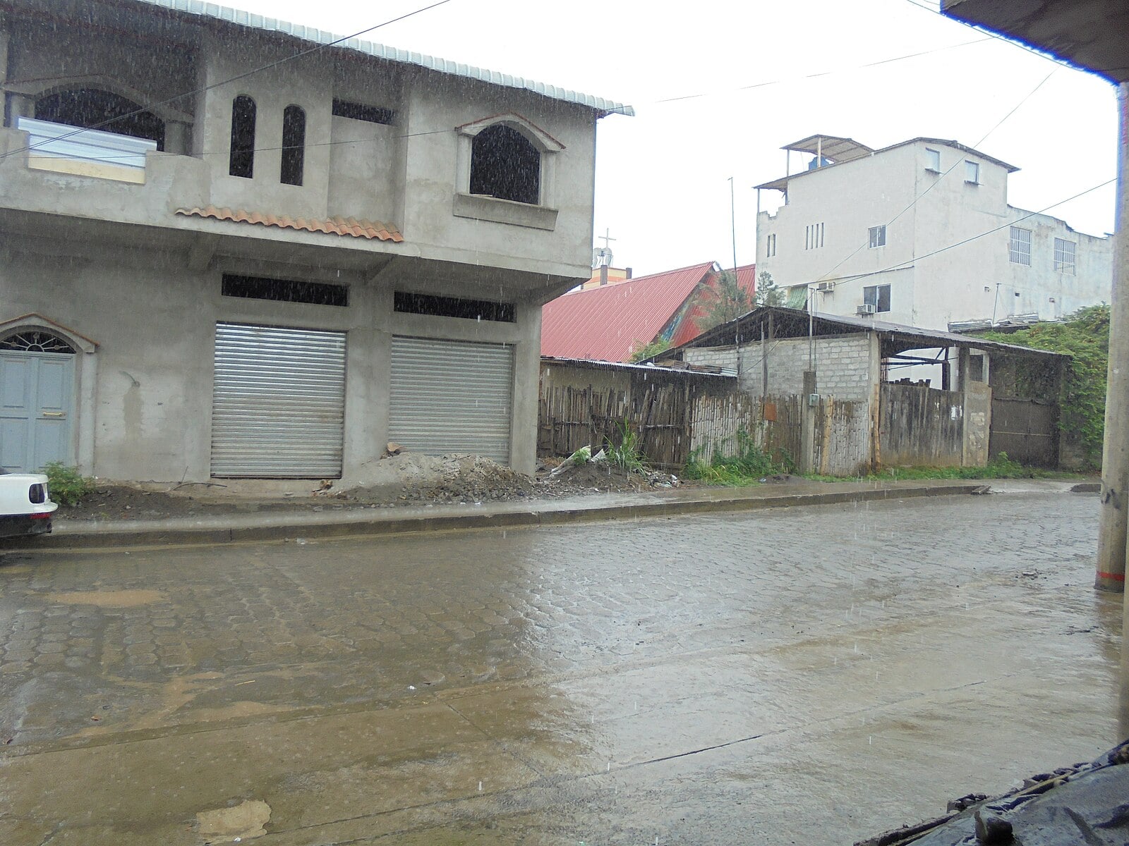 A rain-soaked paved street in El Empalme, Guayas province, Ecuador