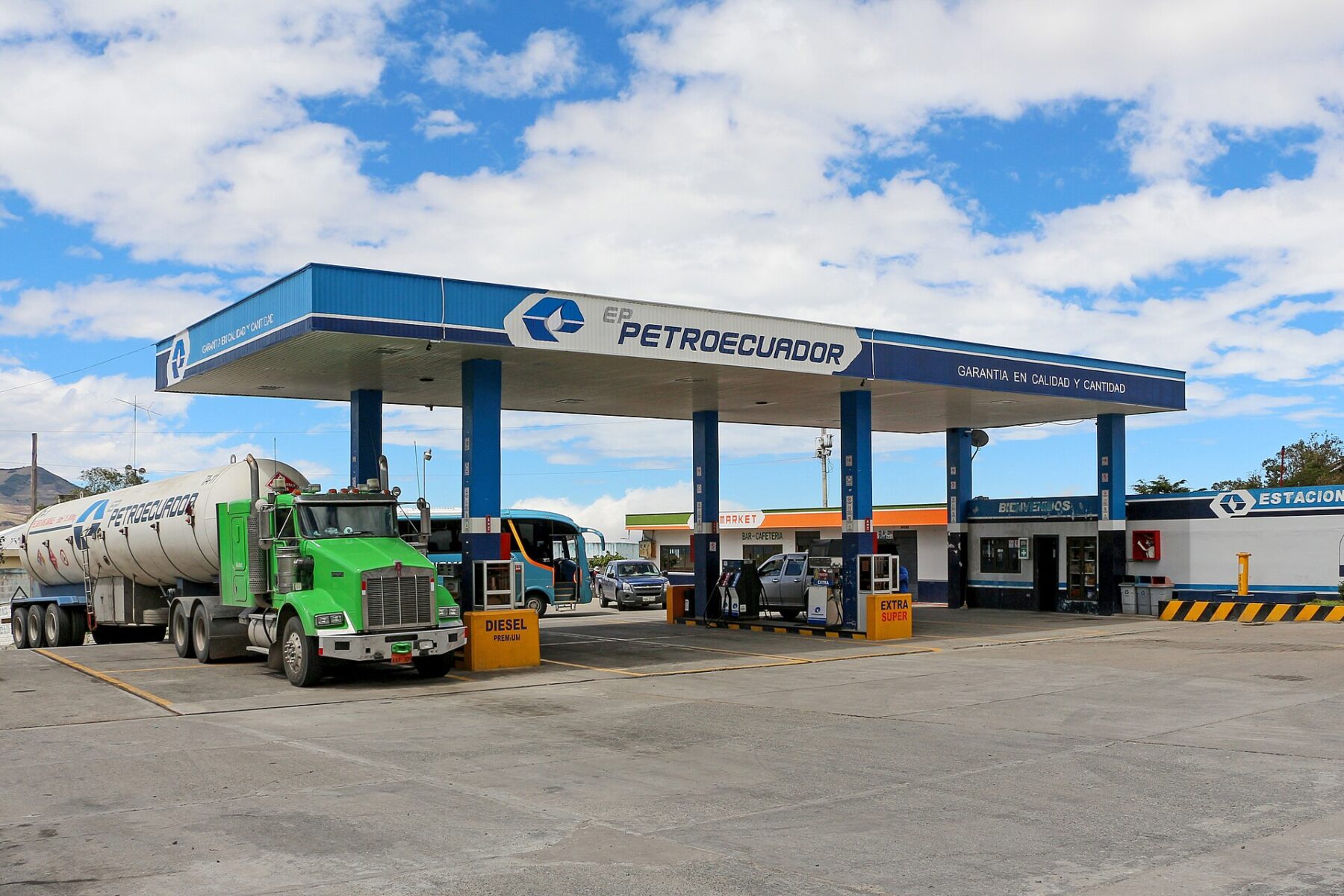 Petroecuador filling station in Ecuador with Diesel Premium and Extra and Súper pumps and a fuel tanker truck