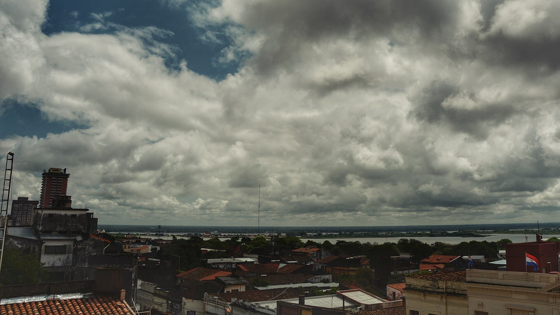 Rooftops of Asunción and the Paraguay River under heavy cloud, host city of the World Skate Games
