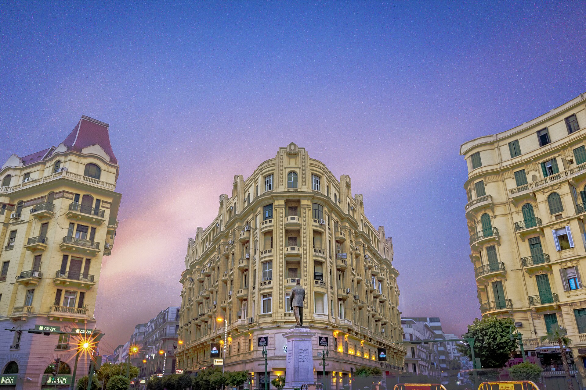 Talaat Harb Square in downtown Cairo at dusk, with the statue of Talaat Harb in front of a corner building