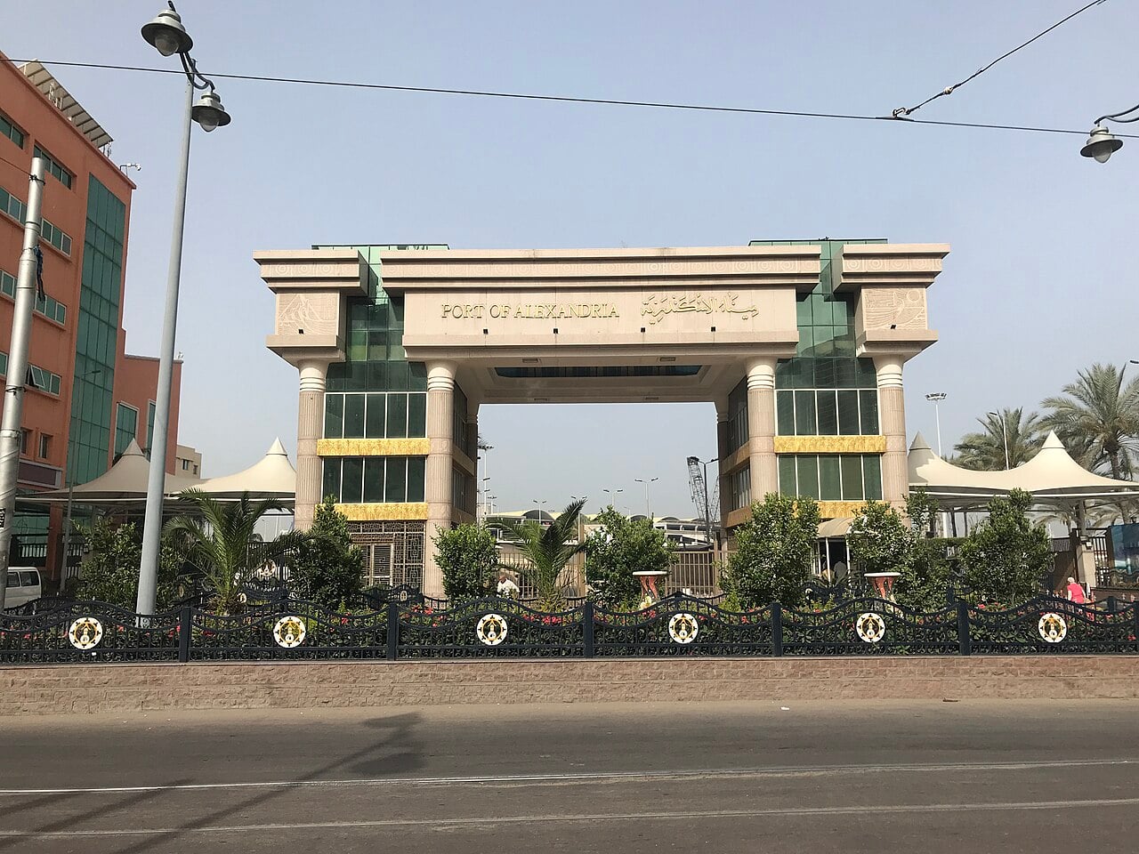 Main entrance gate of the Port of Alexandria in Egypt, a stone arch with the port name in English and Arabic