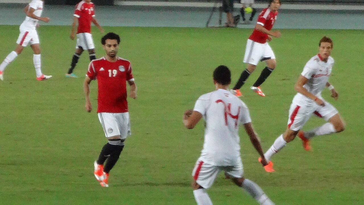 Egyptian footballers in red shirts and Tunisian players in white on the pitch during a 2012 friendly
