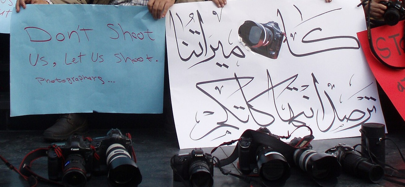 Egypt media and press freedom: cameras and protest placards left on the ground at a photographers’ protest in Cairo