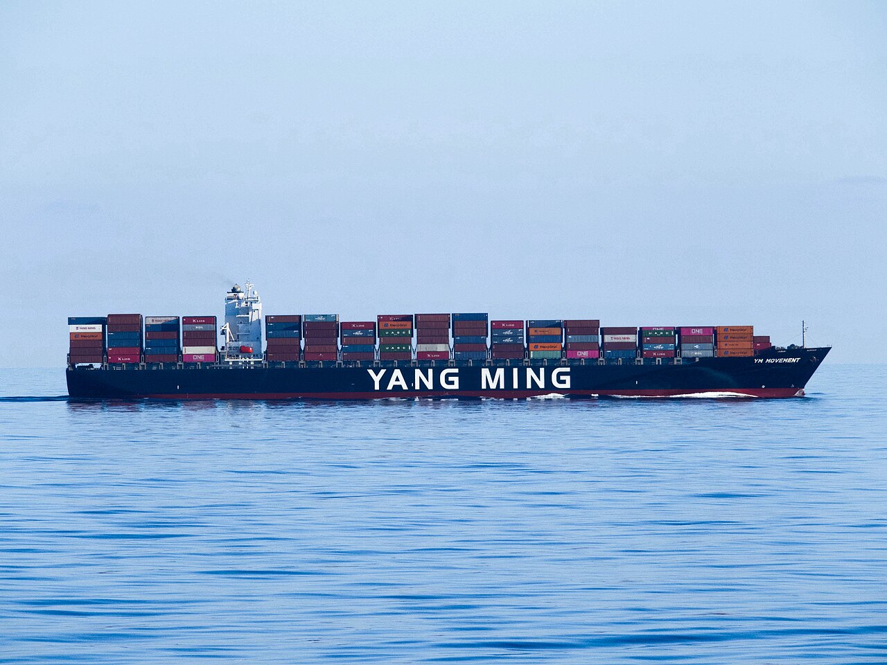 Yang Ming container ship loaded with containers sailing on calm sea