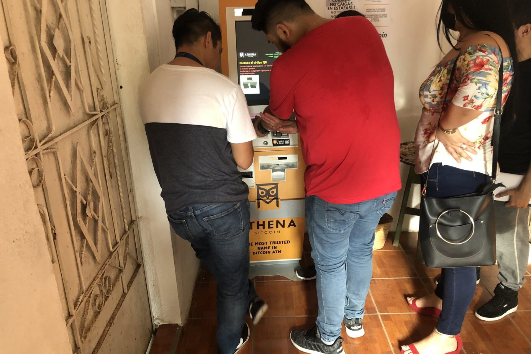 People gather at an Athena Bitcoin ATM in El Salvador