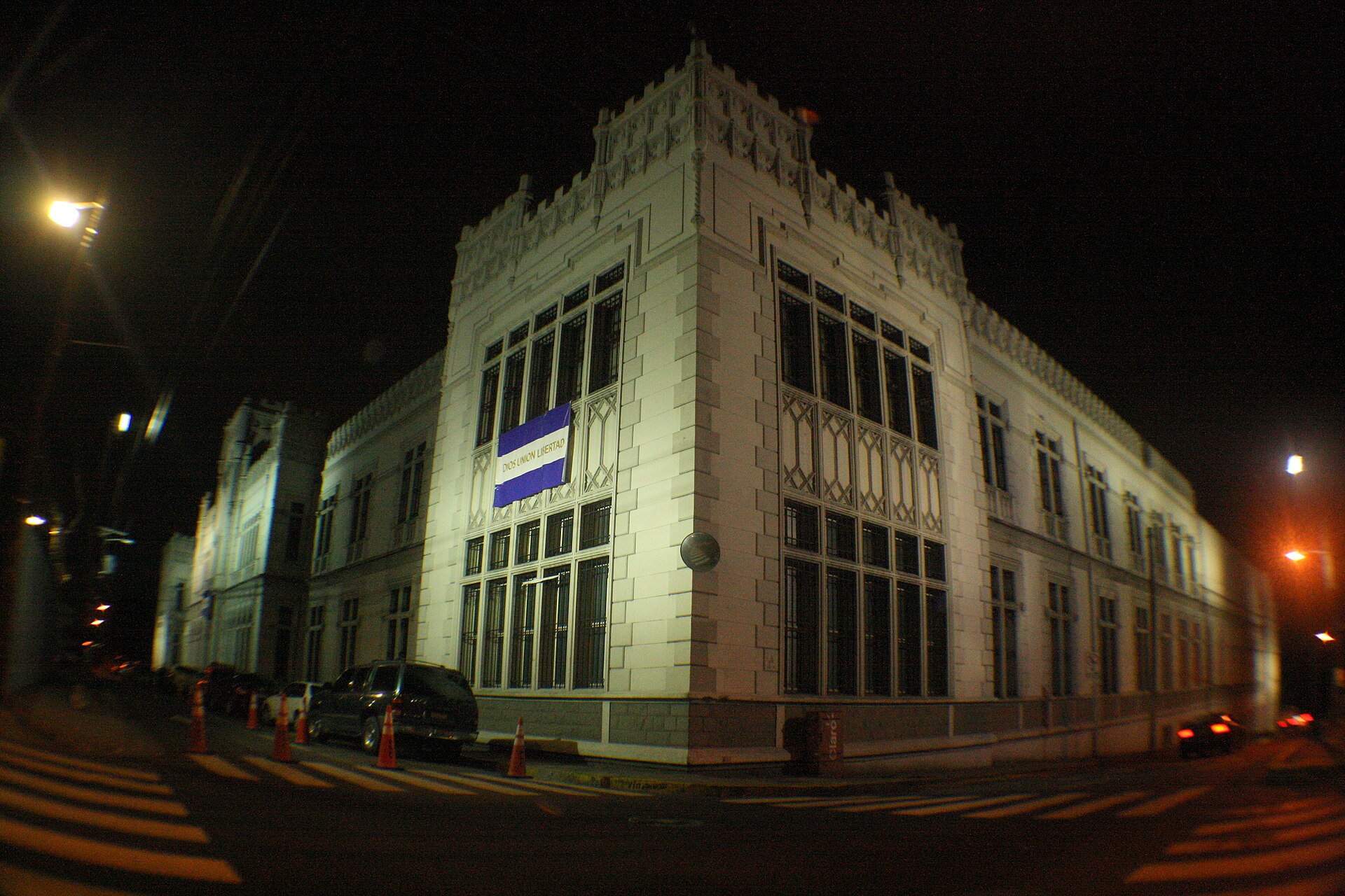 The historic Castillo de la Policía Nacional building in San Salvador lit up at night