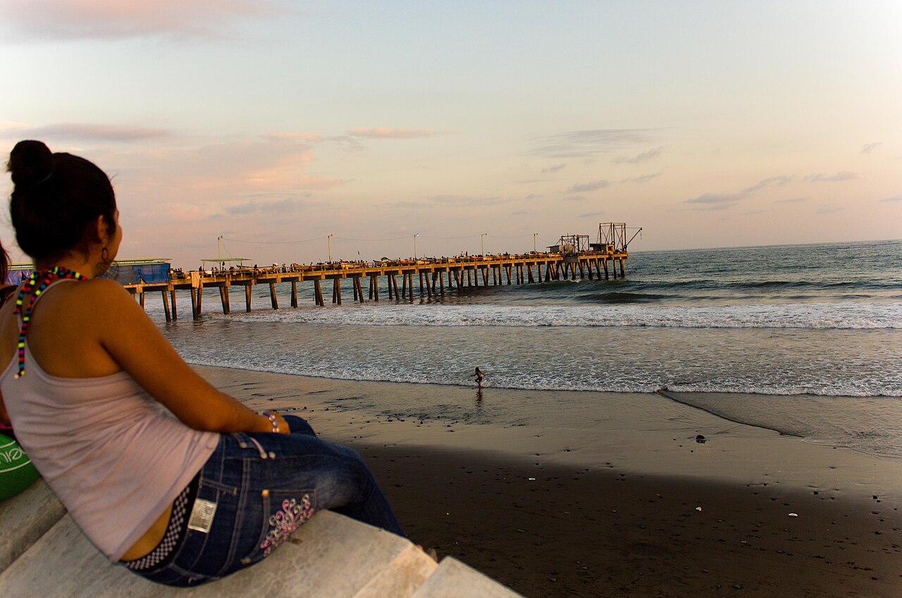 A wooden pier stretching into the Pacific at Puerto de La Libertad at sunset