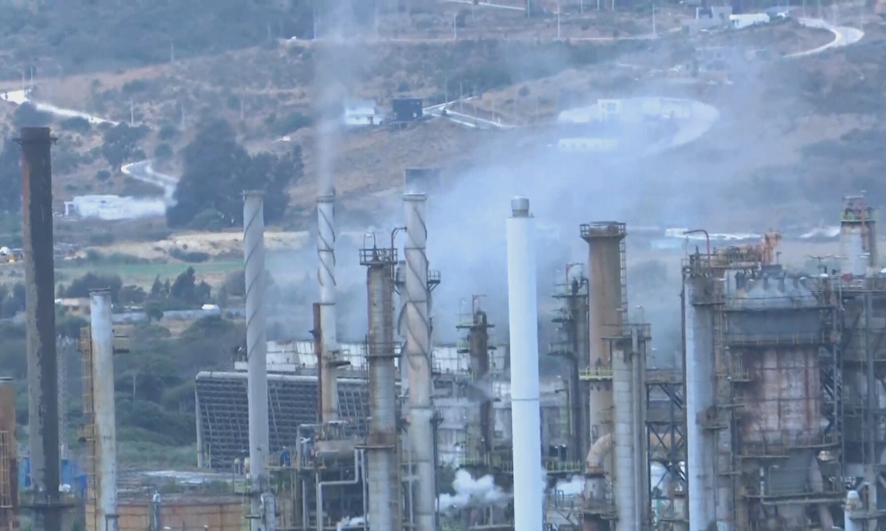 Chimneys and process towers at ENAP's Concón oil refinery in Chile