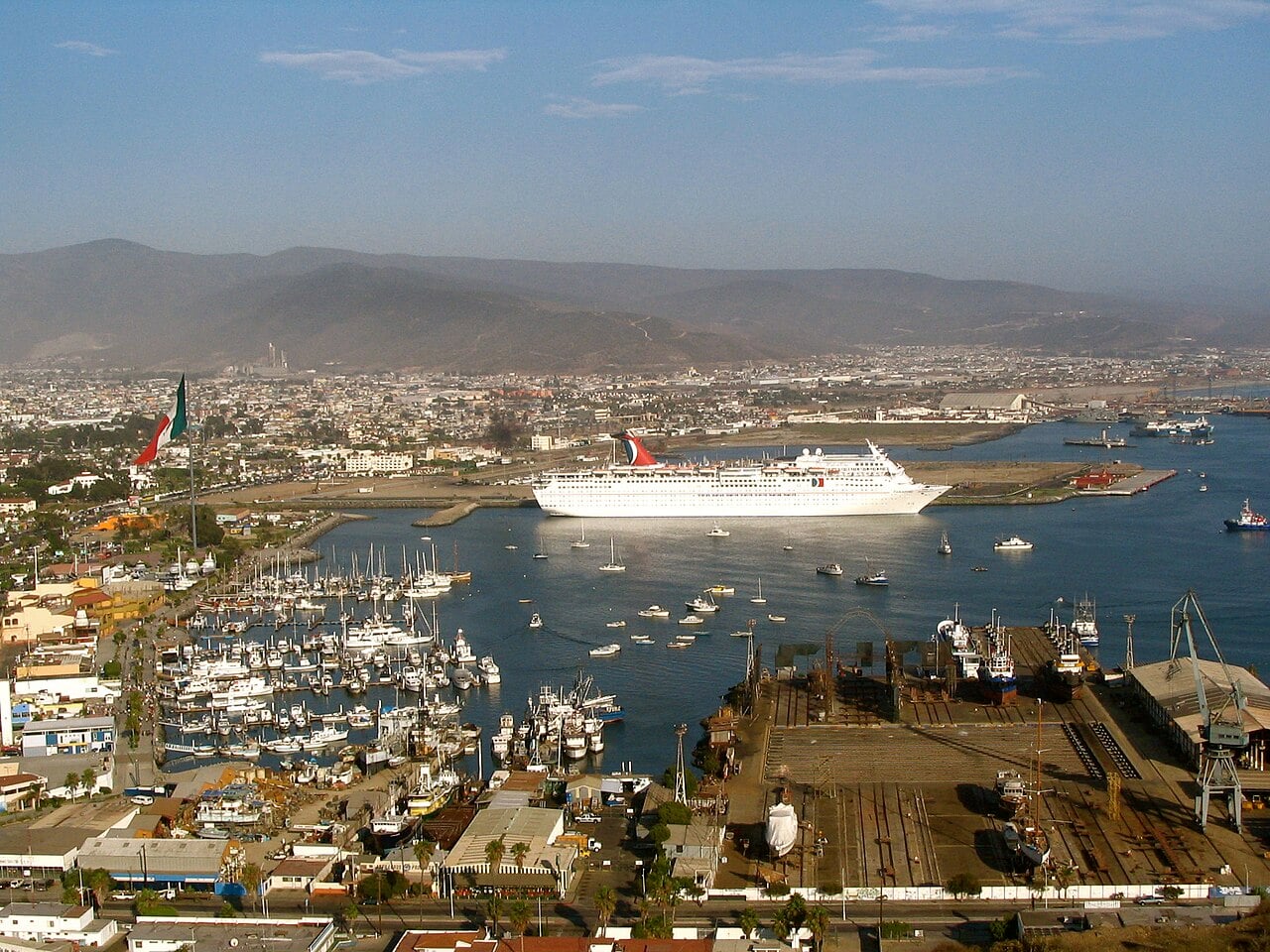 Cruise ship moored in the harbour of Ensenada, Baja California, with marina, shipyard and hills behind the city