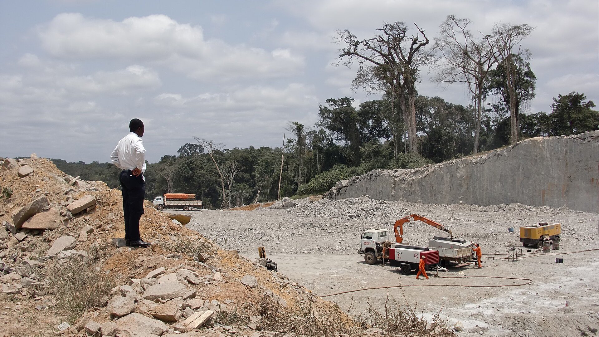 A highway construction site at Oyala, Equatorial Guinea, with earthworks and heavy machinery.