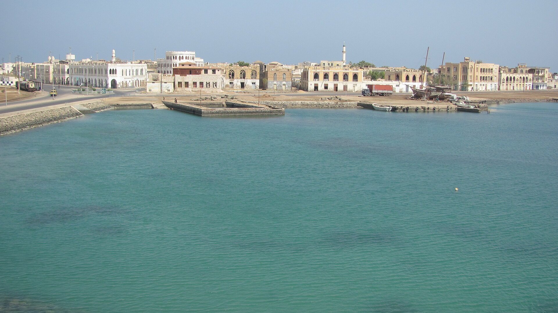 Old town waterfront of Massawa, Eritrea, with Italian-era and Ottoman-style buildings across a turquoise Red Sea harbor