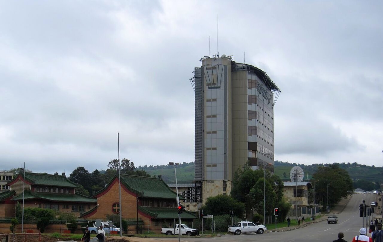 Street in central Mbabane with a high-rise office tower and a Chinese-style building with green roofs