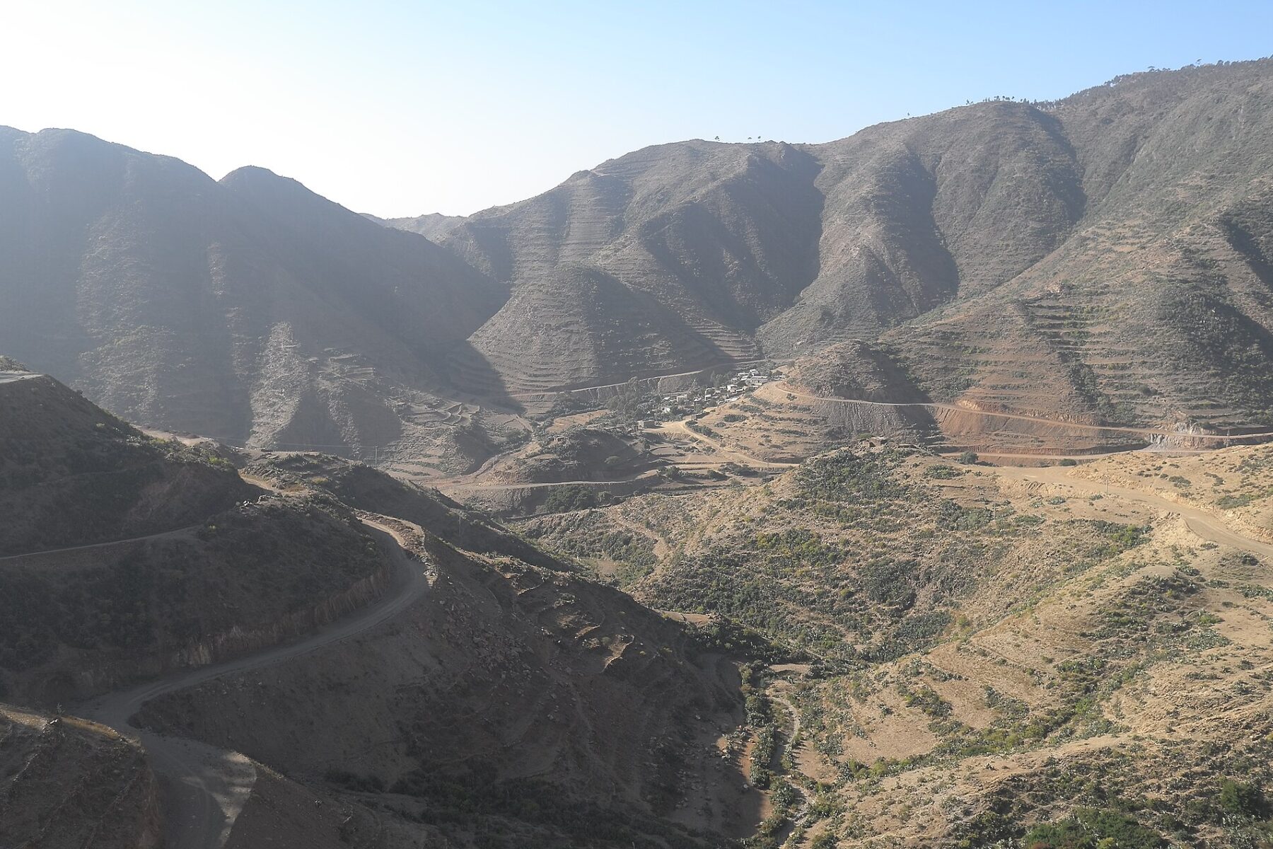 Steep terraced mountains and a winding road in the highlands of Eritrea