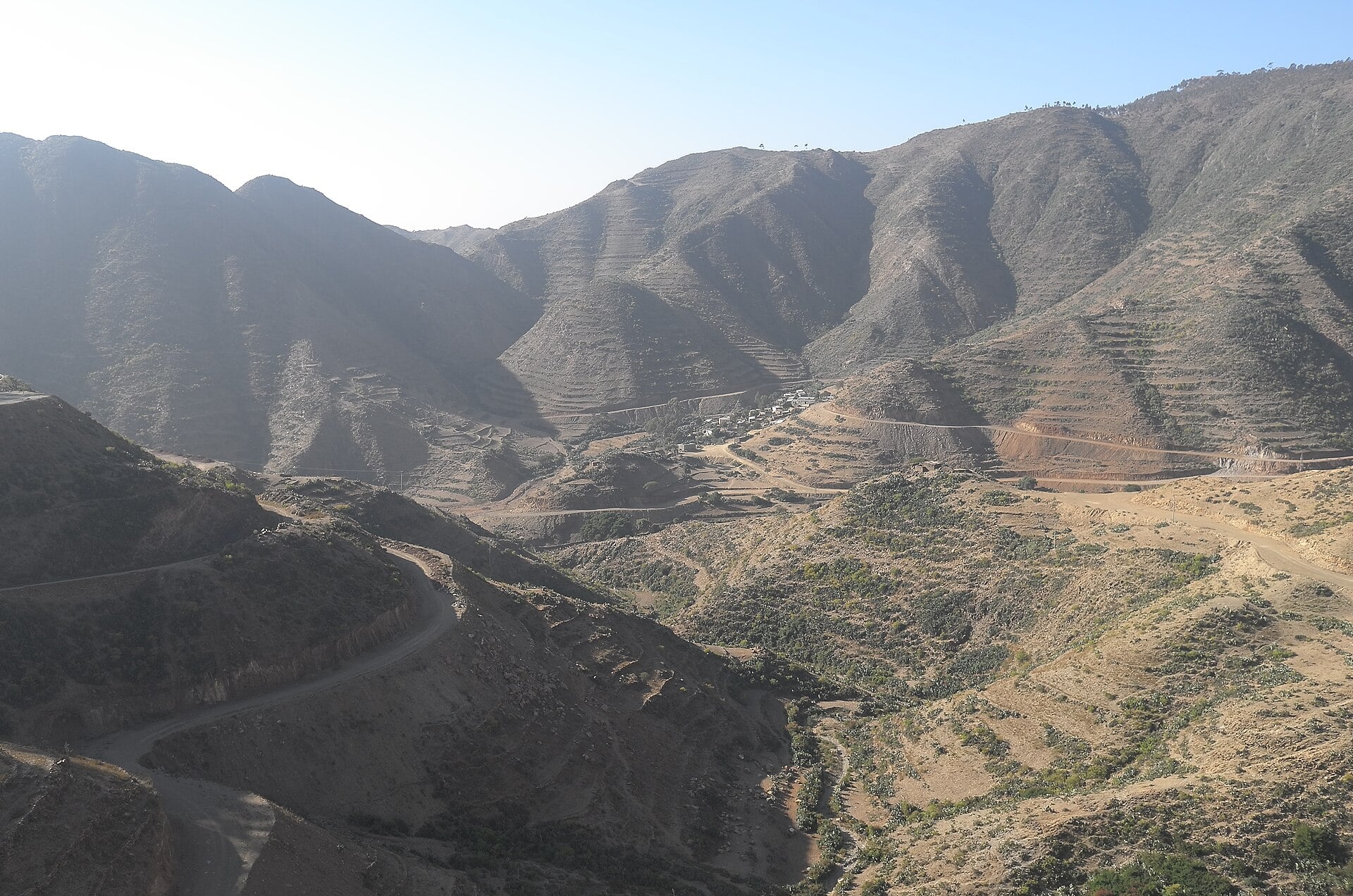 Steep terraced mountains and a winding road in the highlands of Eritrea