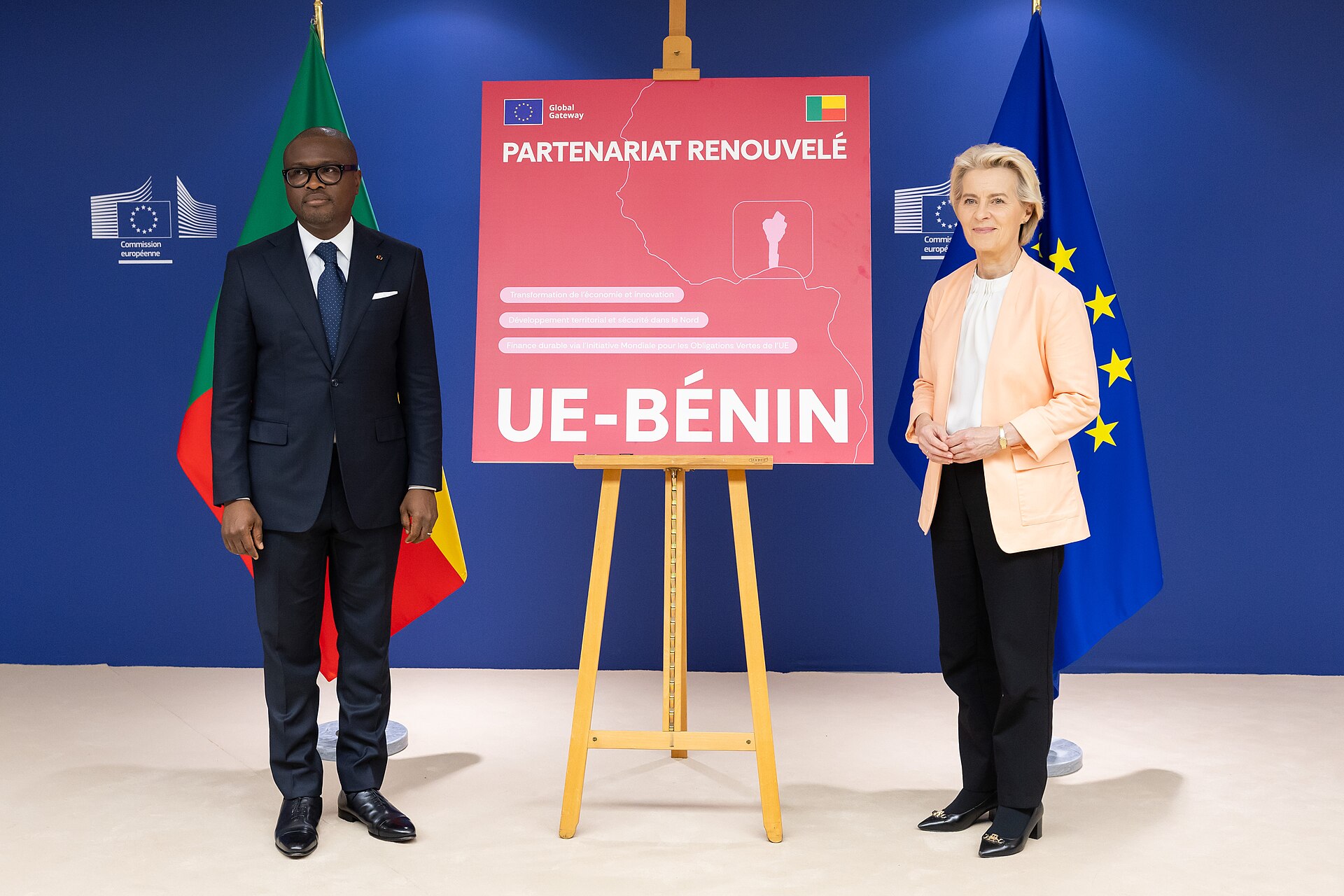 Romuald Wadagni and Ursula von der Leyen stand beside a red EU-Benin Global Gateway partnership board in Brussels