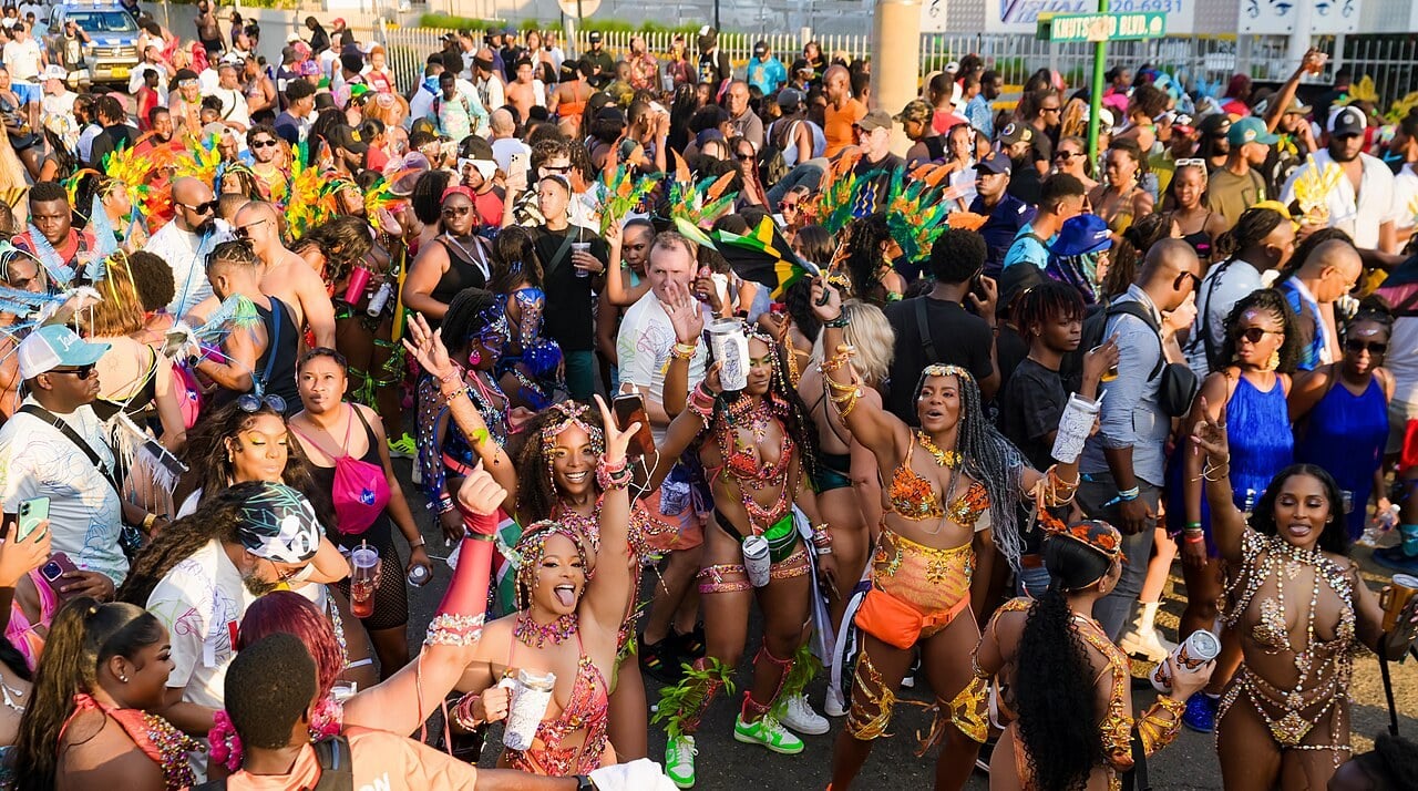 Costumed masqueraders dancing on Knutsford Boulevard in New Kingston, Jamaica, during the Road March