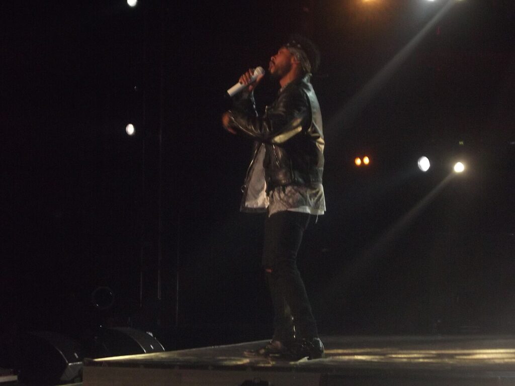 Man singing on stage with microphone