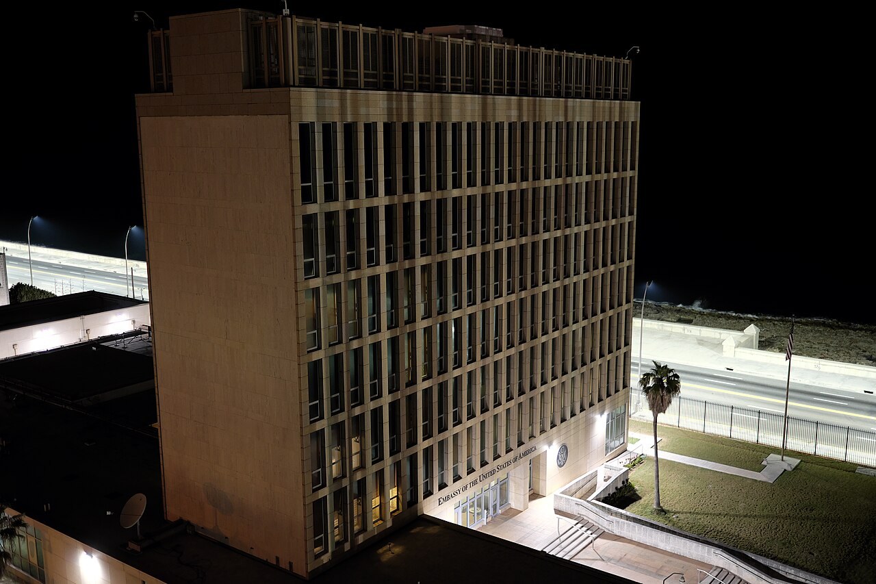 Henry Constantín - The US Embassy building on the Malecón seafront in Havana, Cuba, at night