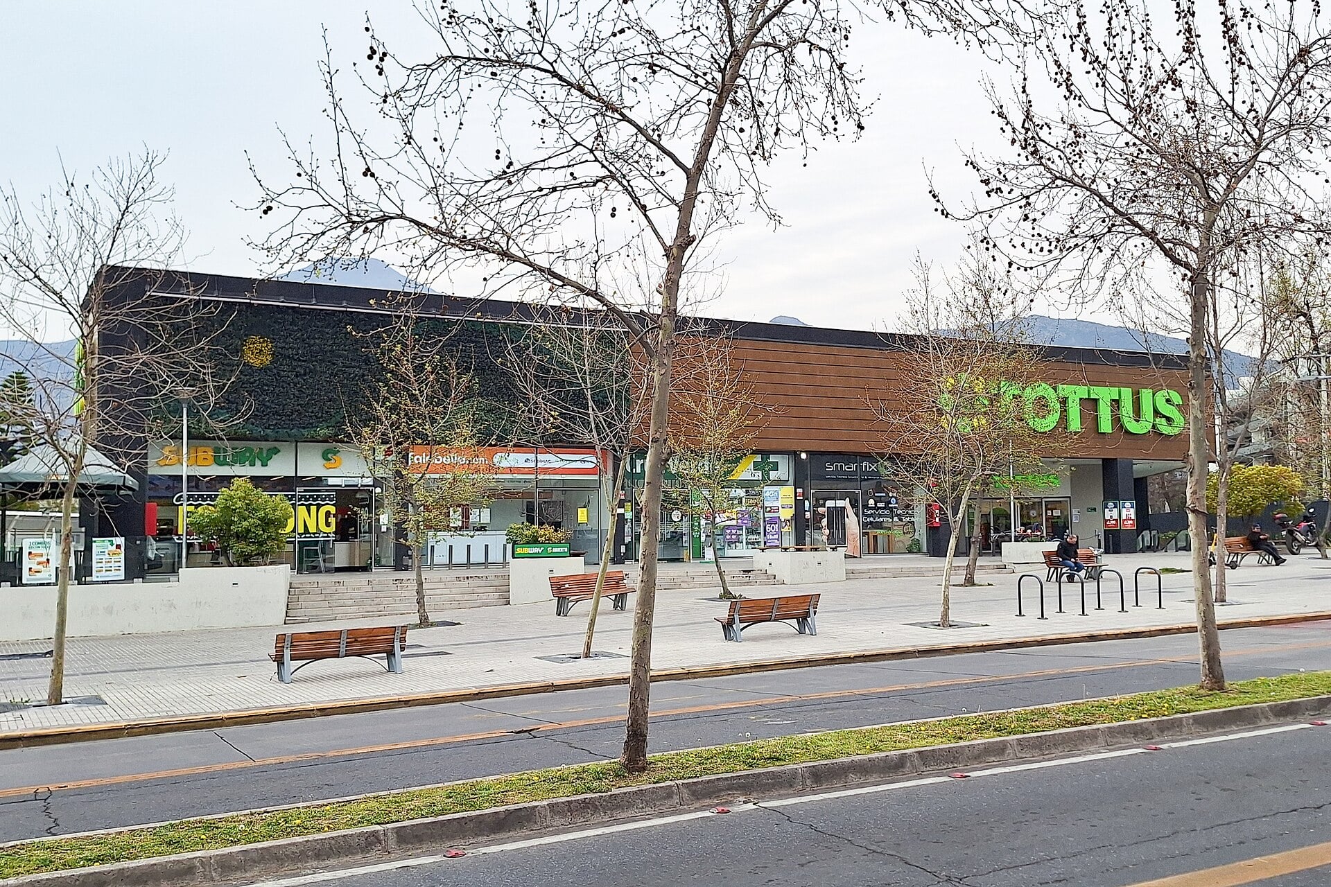 A Tottus supermarket of Grupo Falabella in Vitacura, Santiago, Chile, seen across a tree-lined avenue